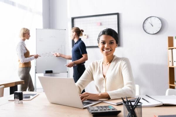 A procurement professional reviewing vendor records in the office
